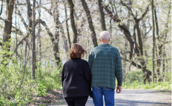Older adult couple walking side by side