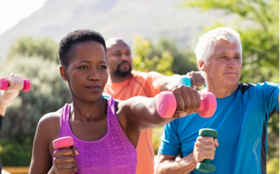 Older adults performing exercises with hand weights. 